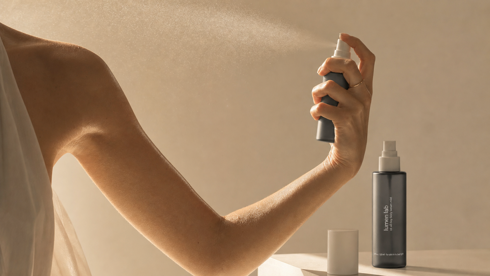Applying Lumen Lab body serum mist fine mist catching warm light