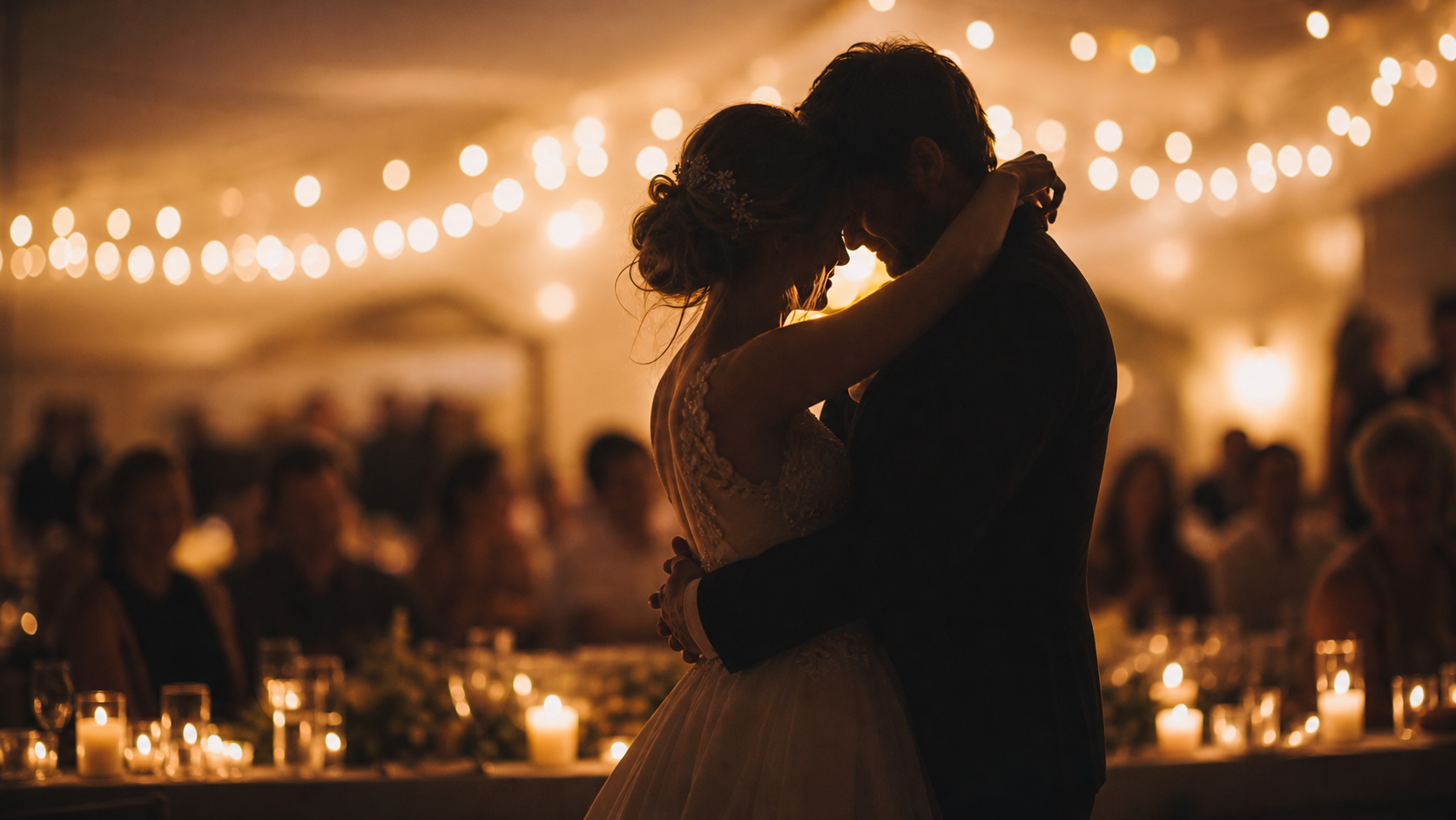 A couple sharing an intimate wedding dance moment in warm candlelight