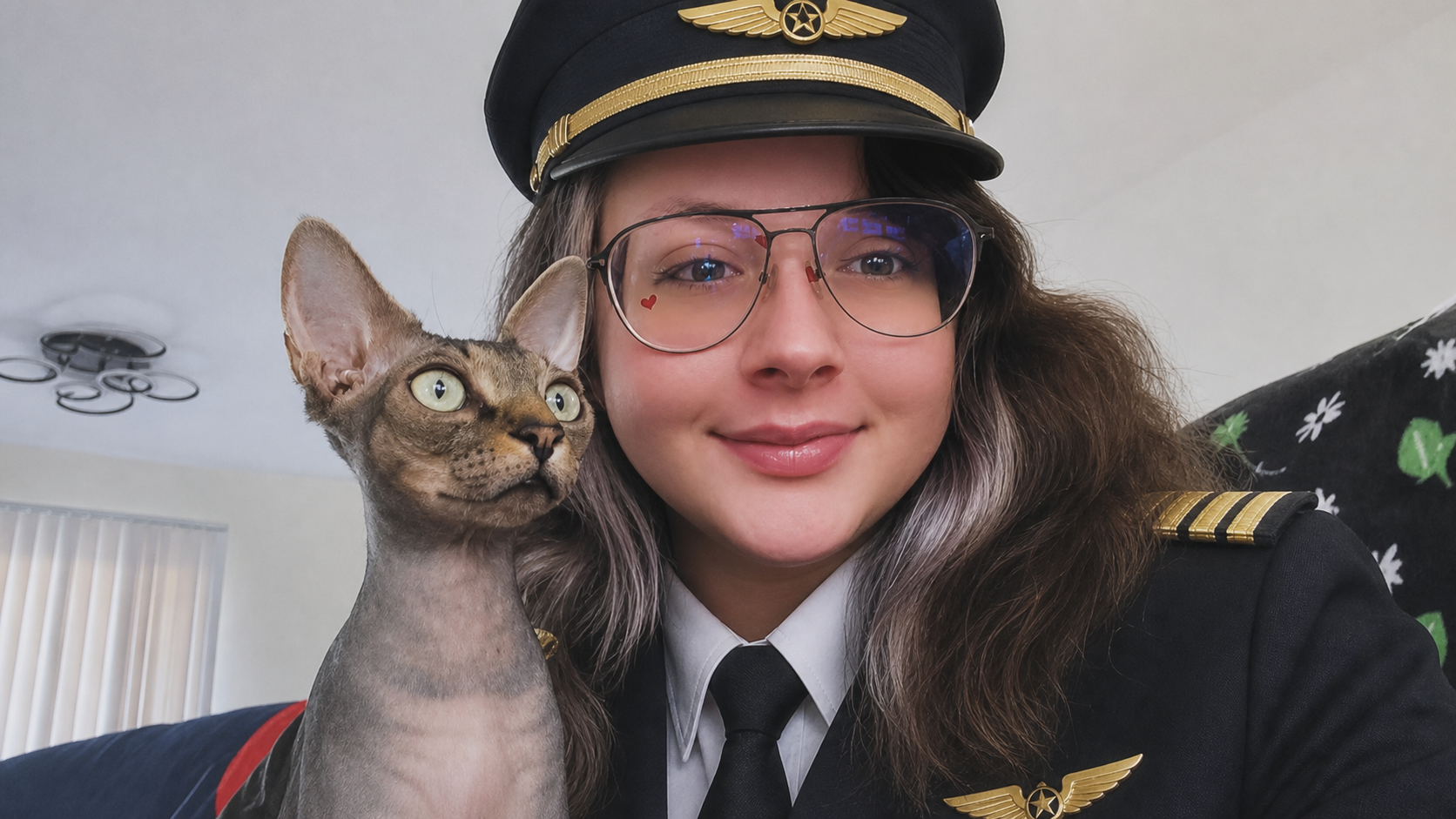 Patricia styled as an airline pilot holding a cat