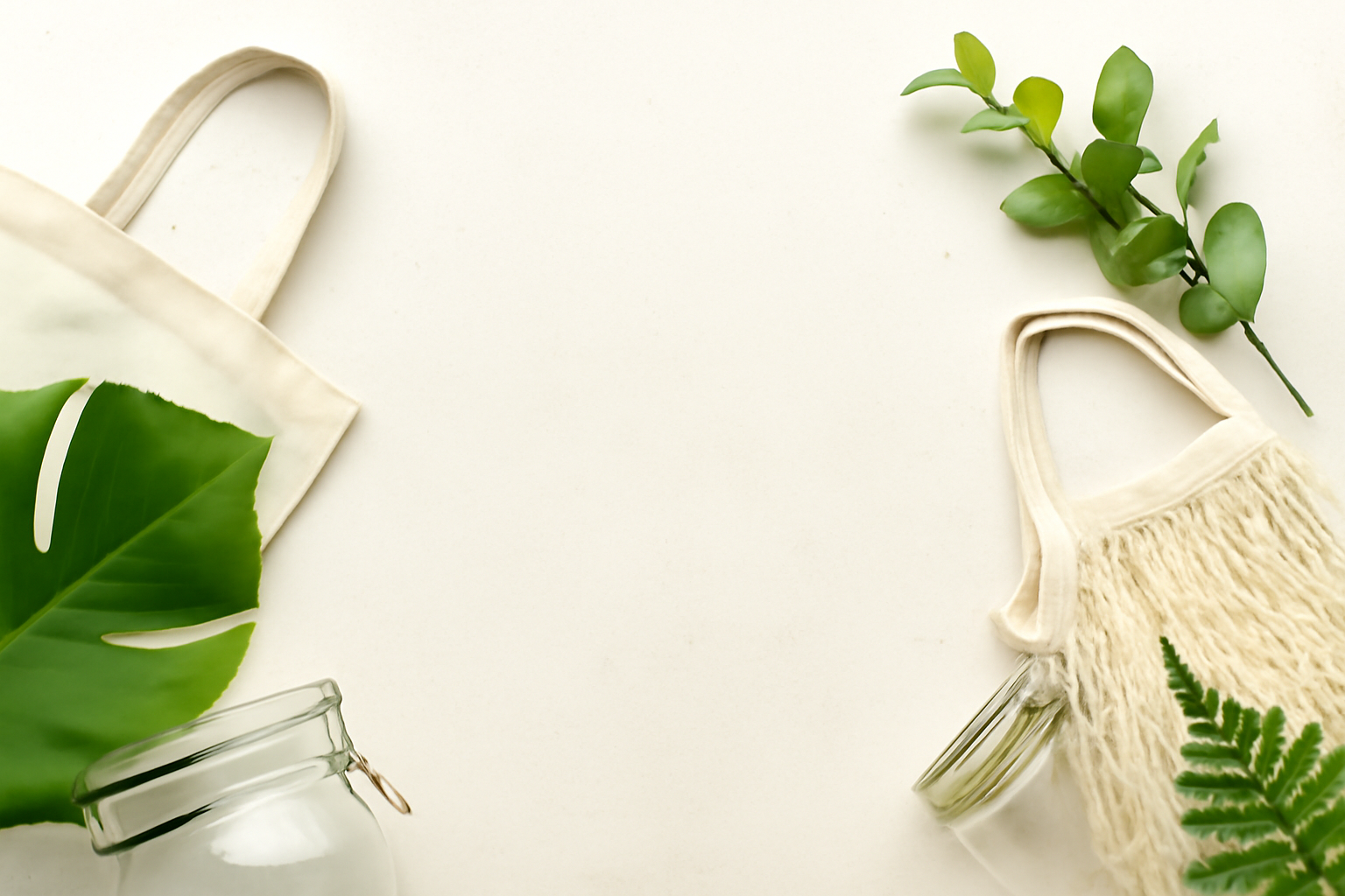 Zero waste living essentials including reusable bags, glass jars, and eco-friendly products